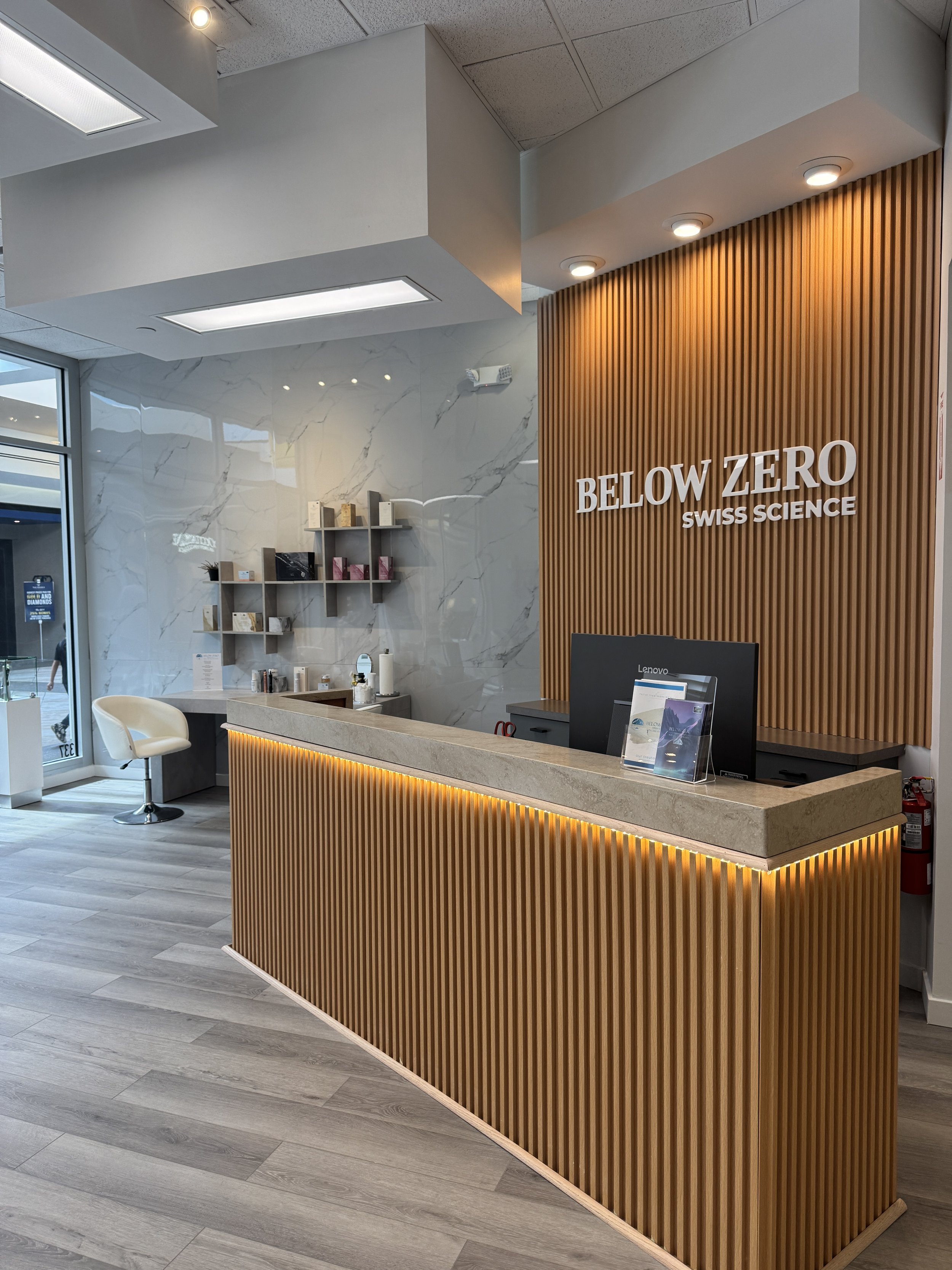Below Zero Swiss Science reception with wood slat wall and consultation desk